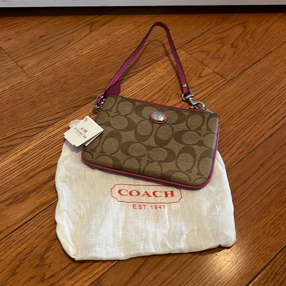 (1070) Coach signature khaki and fuchsia wristlet with silver hardware
